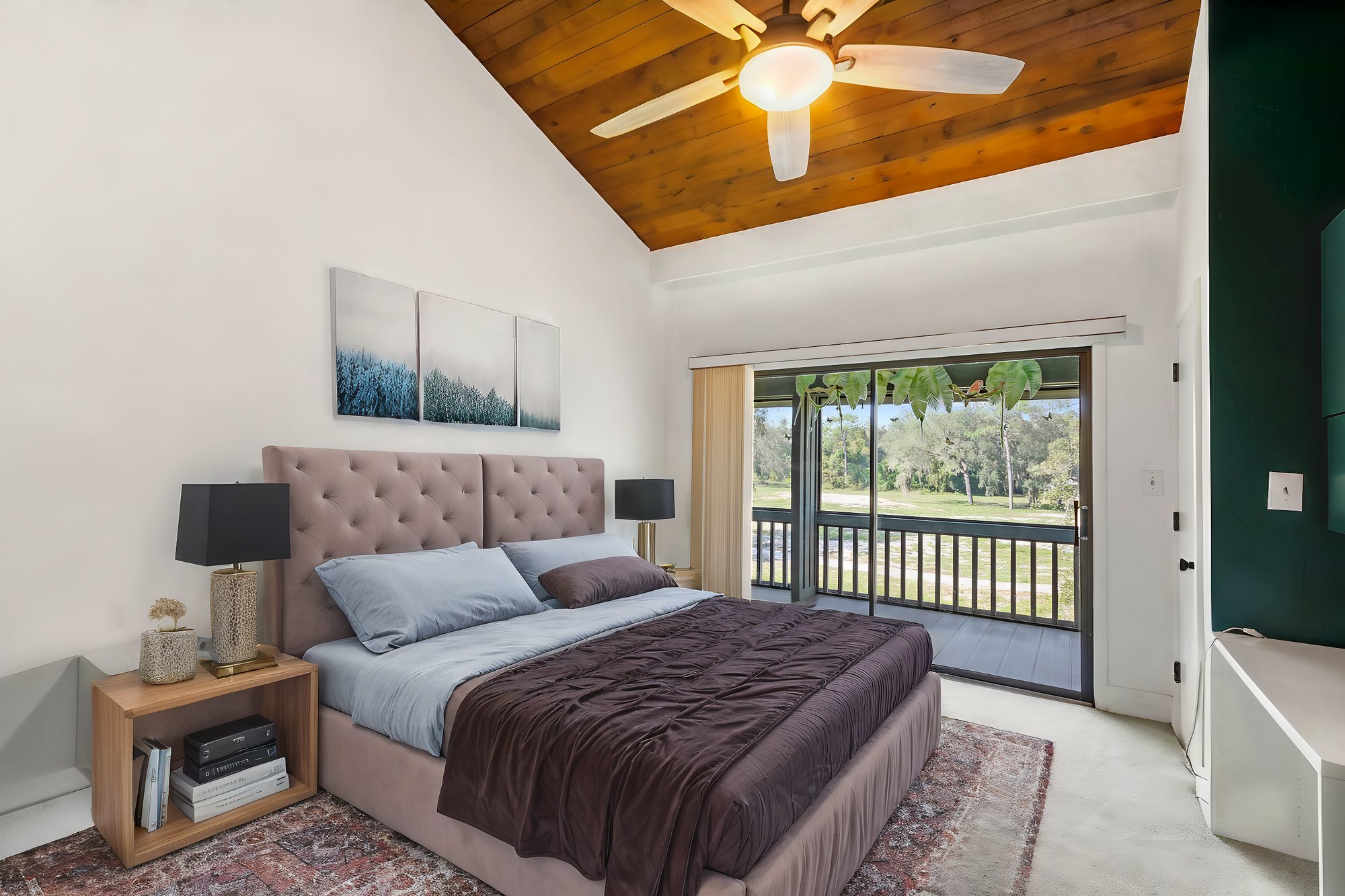 bedroom with brown bed sheets and sliding door to patio